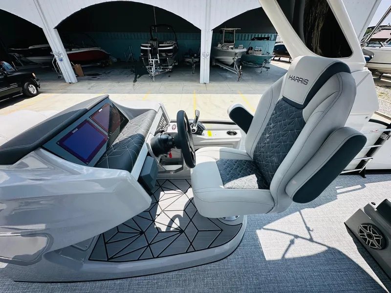 Slide: The Image of 2025 Harris Grand Mariner 250 boat cockpit with modern steering and seating. - 18