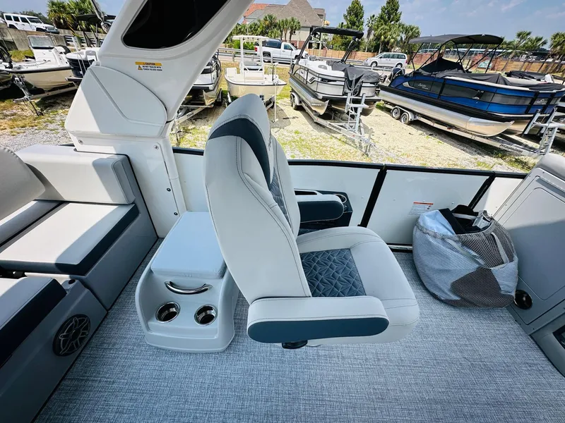 Slide: The Image of 2025 Harris Grand Mariner 250 boat interior with plush seating and cup holders. - 19