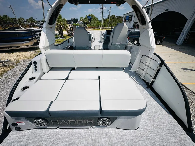 Slide: The Image of 2025 Harris Grand Mariner 250 pontoon boat with spacious seating and modern design. - 23