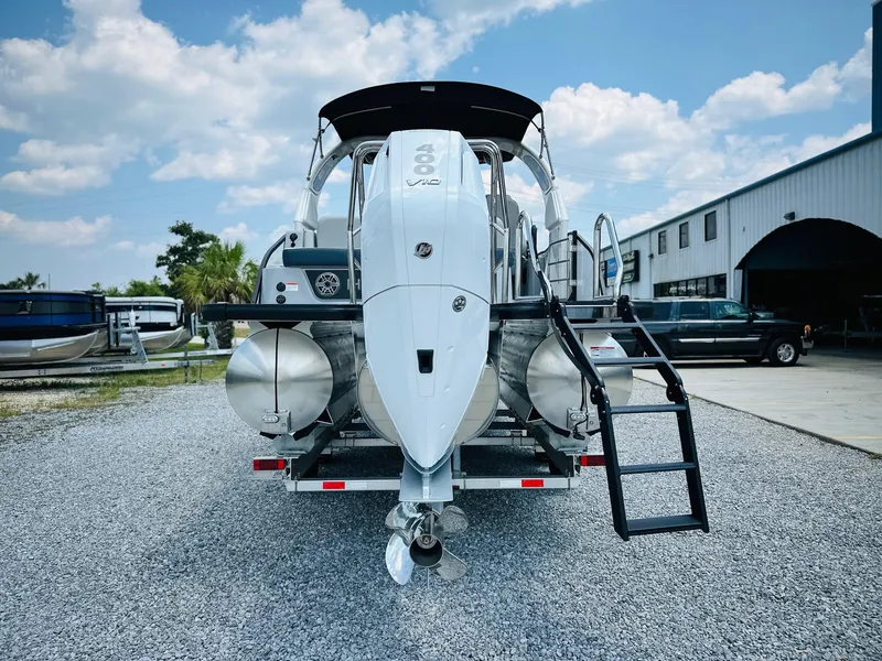 Slide: The Image of 2025 Harris Grand Mariner 250 pontoon boat on trailer, rear view, outdoors. - 3