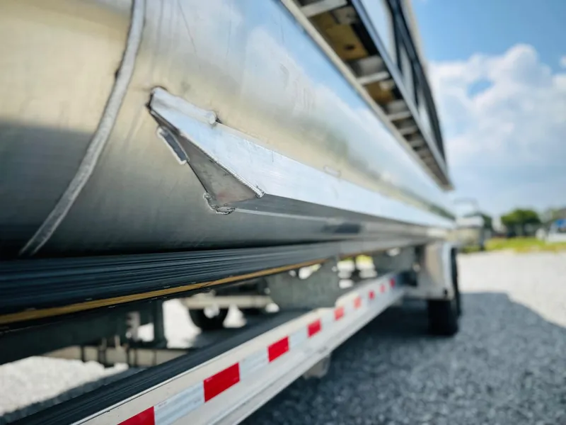 Slide: The Image of 2025 Harris Grand Mariner 250 pontoon boat on trailer, close-up view. - 8