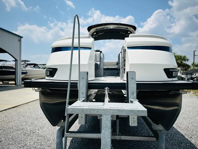 Slide: The Image of 2025 Harris Grand Mariner 250 boat with dual engines, displayed outdoors under a blue sky. - 9
