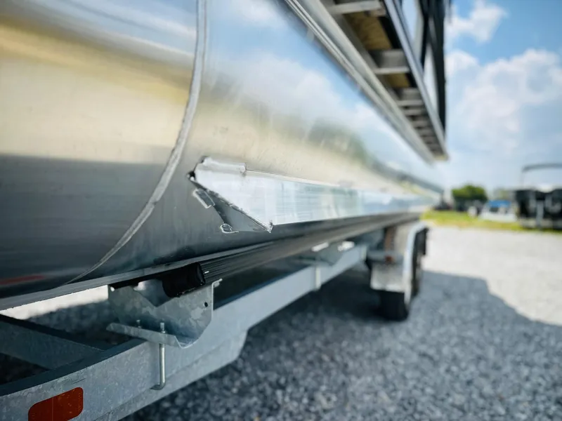 Slide: The Image of 2025 Harris Cruiser 230 pontoon boat on trailer, close-up view. - 6