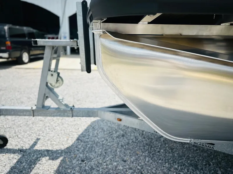 Slide: The Image of 2025 Harris Cruiser 230 boat on trailer, close-up of aluminum hull. - 7