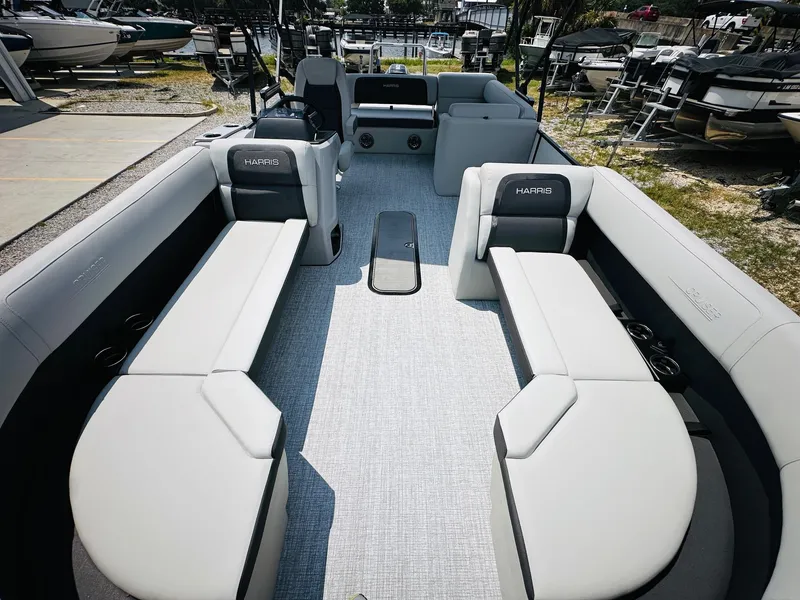 Slide: The Image of 2025 Harris Cruiser 230 pontoon boat with spacious seating and modern design. - 9