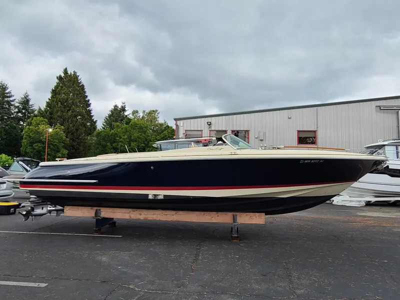 The Image of 2011 Chris-Craft Corsair 28 boat on display outdoors, overcast sky. - 0