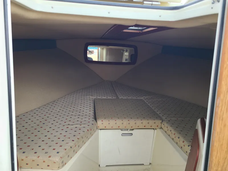 Slide: The Image of Interior cabin of 2011 Chris-Craft Corsair 28 with cushioned seating and storage. - 12