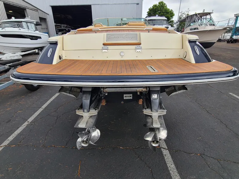 Slide: The Image of 2011 Chris-Craft Corsair 28 boat with dual propellers, docked in a marina. - 2