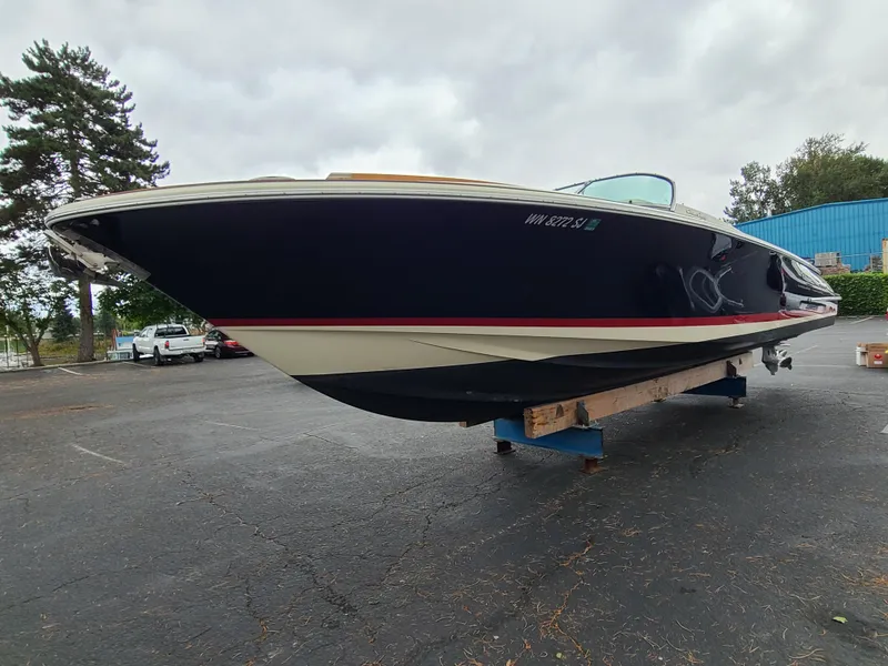 Slide: The Image of 2011 Chris-Craft Corsair 28 boat on display in a parking lot. - 4