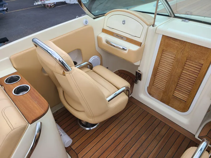 Slide: The Image of 2011 Chris-Craft Corsair 28 interior with beige seating and wooden accents. - 7