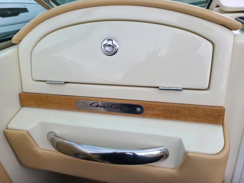 Slide: The Image of 2011 Chris-Craft Corsair 28 dashboard with wood and chrome accents. - 8