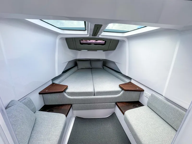 Slide: The Image of 2024 Axopar 37XC CROSS CABIN interior with modern seating and skylights. - 11
