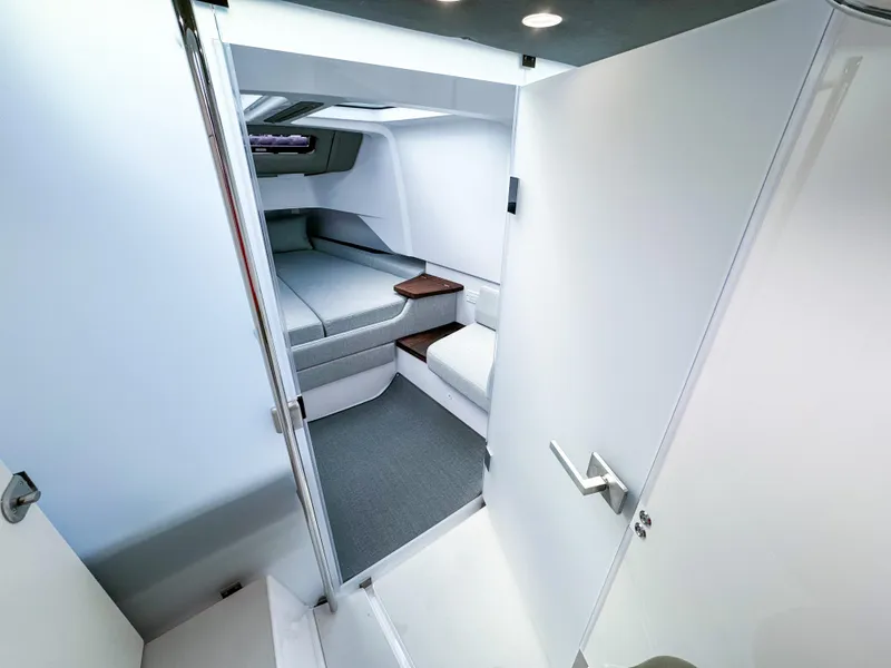 Slide: The Image of 2024 Axopar 37XC CROSS CABIN interior with modern sleeping area and sleek design. - 14
