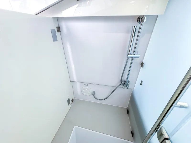 Slide: The Image of Shower area in 2024 Axopar 37XC CROSS CABIN boat, featuring modern fixtures and sleek design. - 17