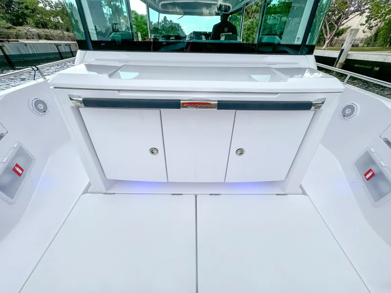Slide: The Image of 2024 Axopar 37XC CROSS CABIN interior with sleek white cabinetry and modern design. - 19