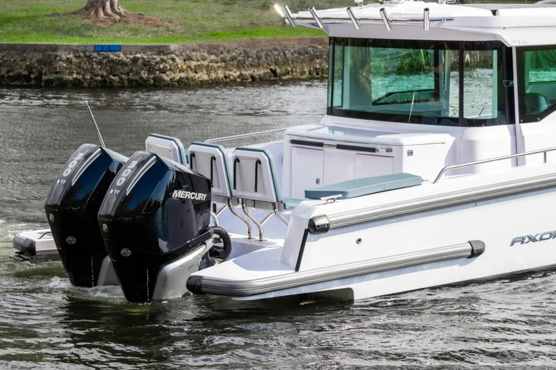 Slide: The Image of 2024 Axopar 37XC CROSS CABIN with dual Mercury engines on water. - 4