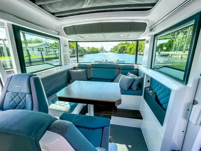 Slide: The Image of 2024 Axopar 37XC CROSS CABIN interior with luxurious seating and panoramic windows. - 9