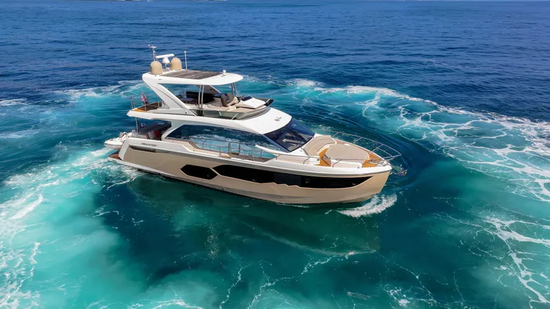Slide: The Image of Luxurious 2019 Absolute 58 FLY yacht cruising in clear blue ocean waters. - 1