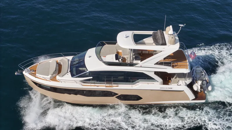 Slide: The Image of Luxury 2019 Absolute 58 FLY yacht cruising on open water. - 19