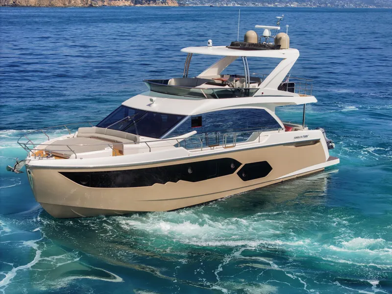 Slide: The Image of Luxury 2019 Absolute 58 FLY yacht cruising on clear blue waters. - 6