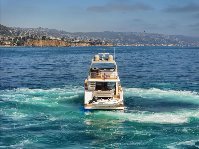 Slide: The Image of Luxury Absolute 58 FLY yacht cruising in scenic coastal waters, 2019 model. - 8