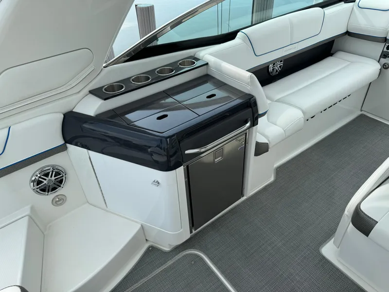 Slide: The Image of 2019 Formula 310 Bowrider OB interior with seating, mini fridge, and cup holders. - 35