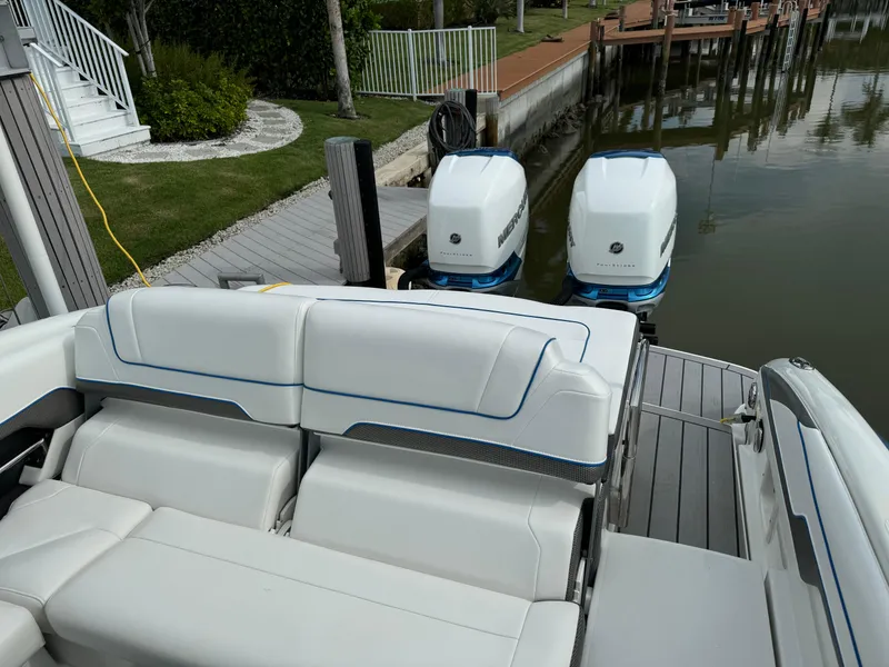 Slide: The Image of 2019 Formula 310 Bowrider OB with dual outboard engines docked by a waterfront. - 38