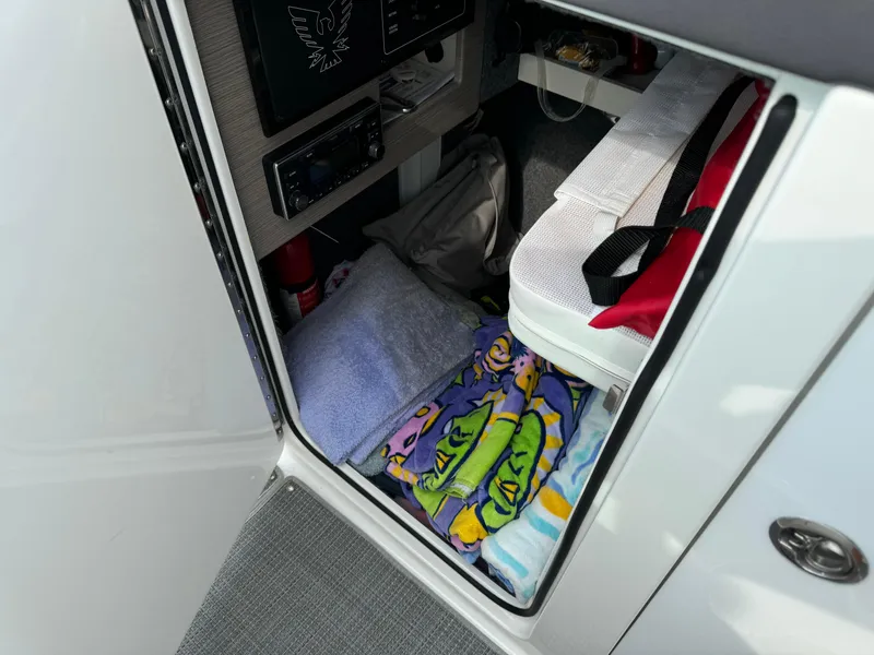 Slide: The Image of 2019 Formula 310 Bowrider OB cabin storage with towels and safety equipment. - 46