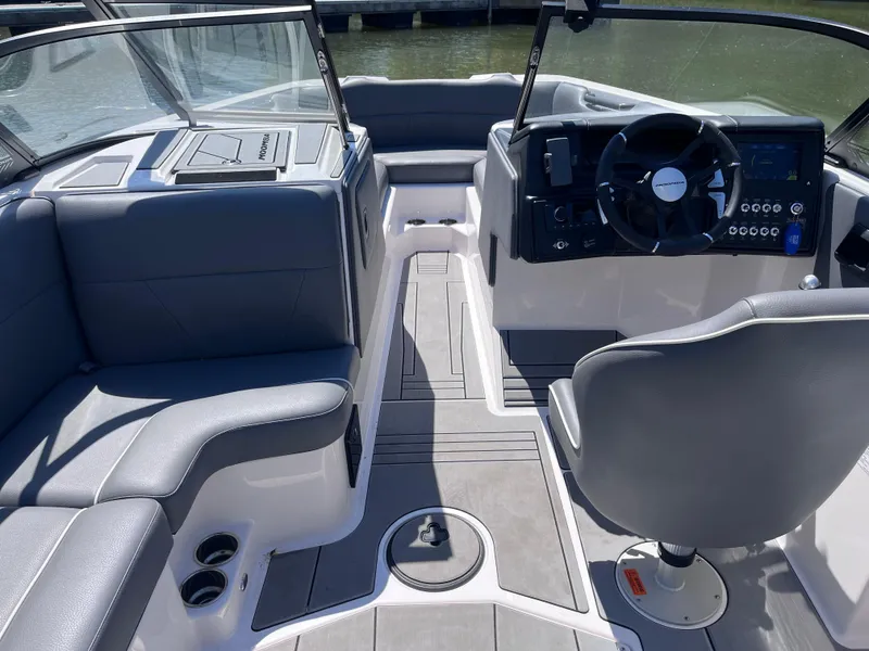 Slide: The Image of 2024 Moomba Max boat interior with gray seating and modern dashboard design. - 14