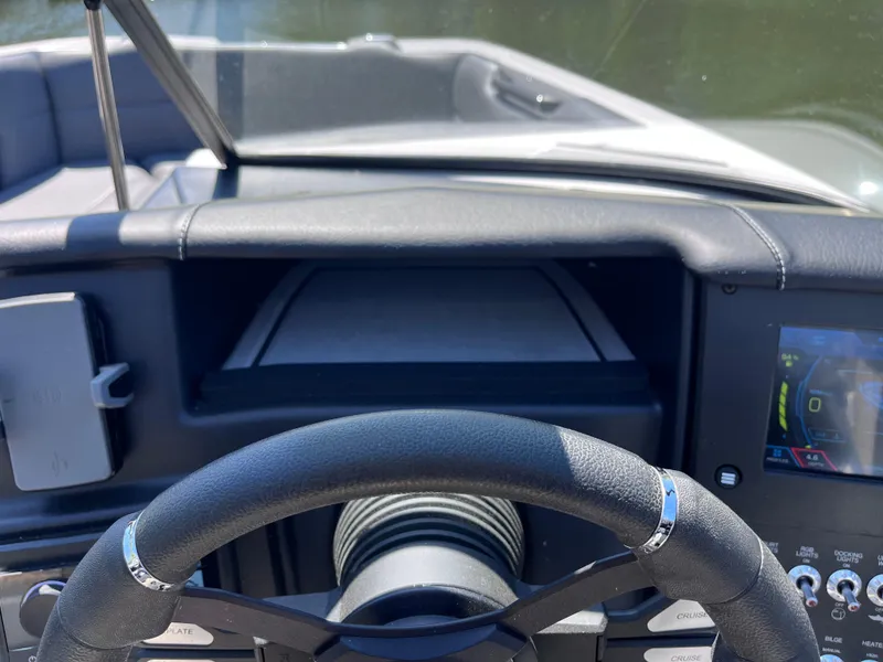 Slide: The Image of 2024 Moomba Max dashboard with steering wheel and control panel. - 16