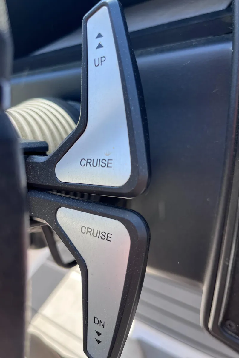 Slide: The Image of 2024 Moomba Max boat controls with cruise adjustment levers labeled "UP" and "DN". - 17