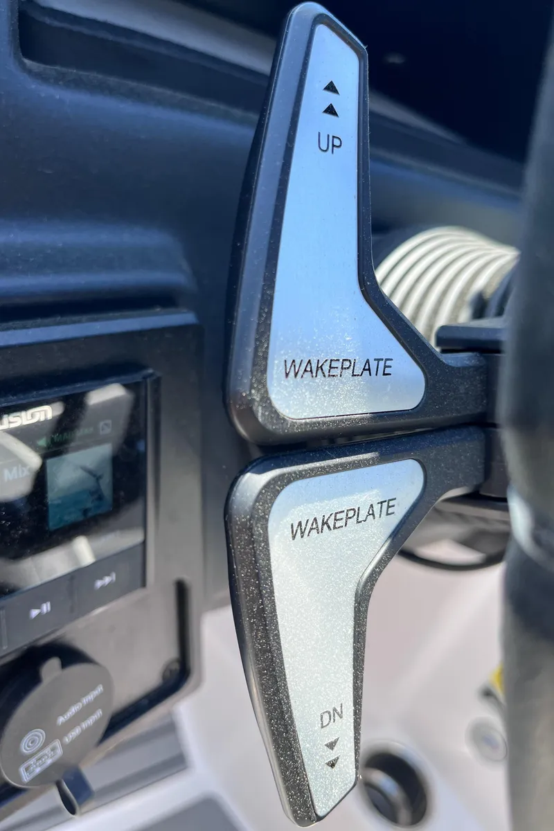 Slide: The Image of 2024 Moomba Max wakeplate controls with up and down adjustment buttons. - 18