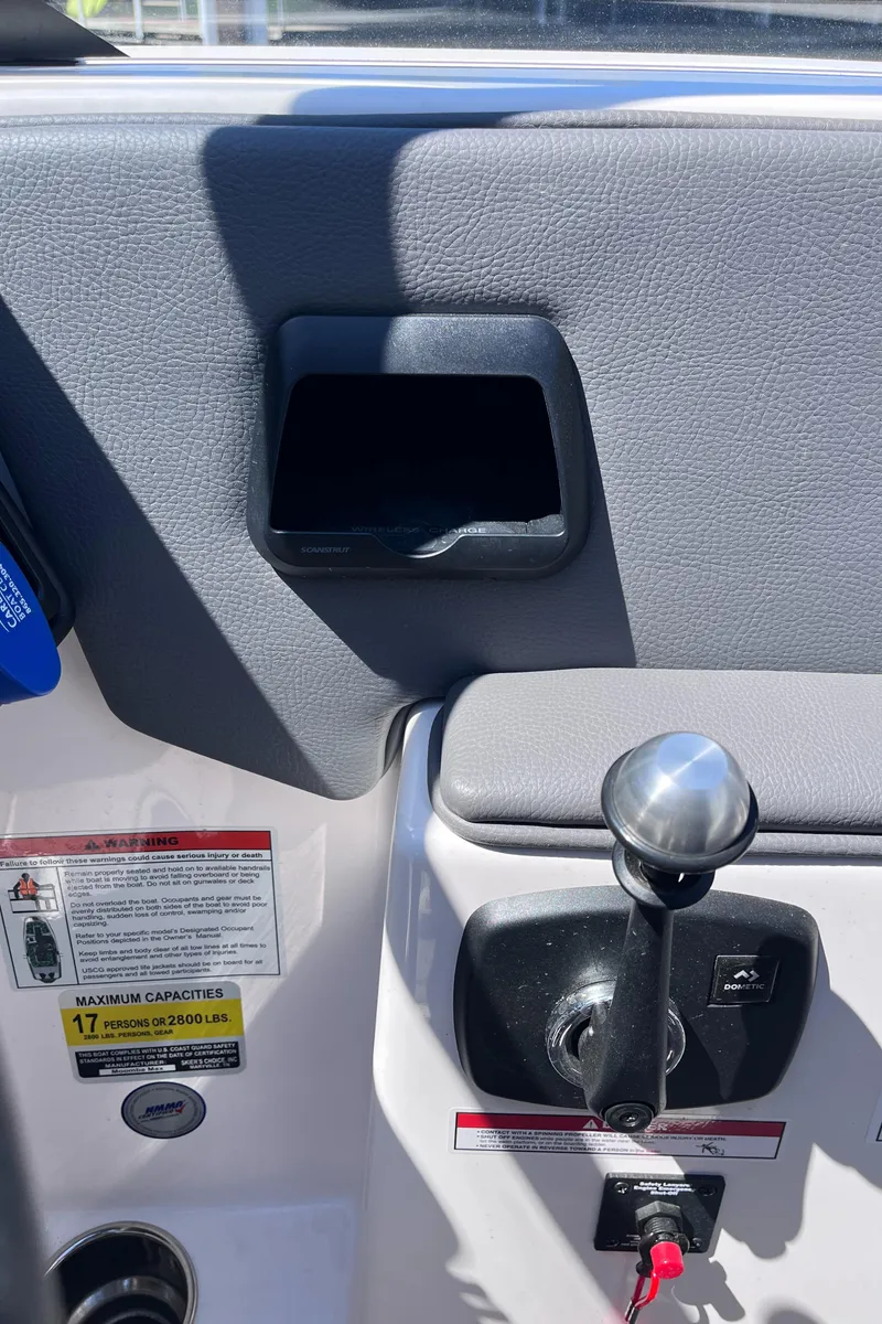 Slide: The Image of 2024 Moomba Max boat interior with control lever and safety instructions. - 21