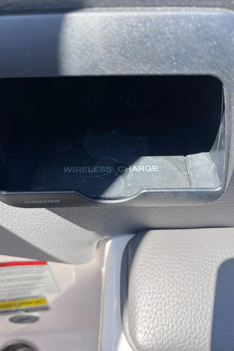 Slide: The Image of 2024 Moomba Max wireless charging compartment in vehicle interior. - 22