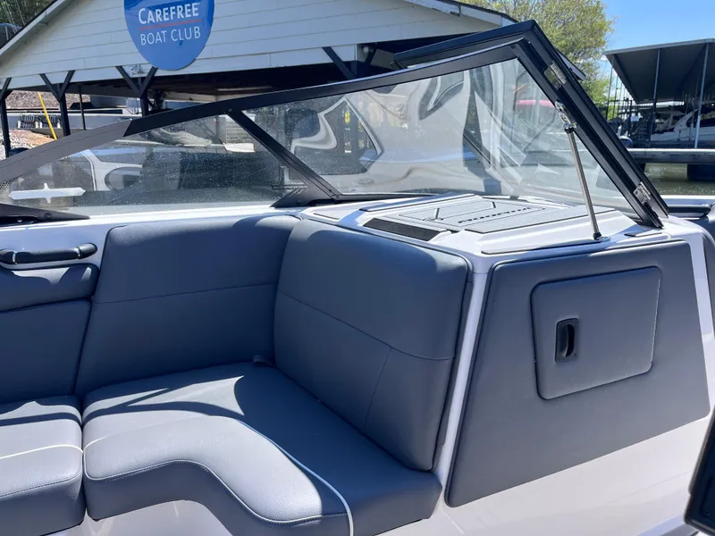 Slide: The Image of 2024 Moomba Max boat interior with gray seating at Carefree Boat Club. - 23