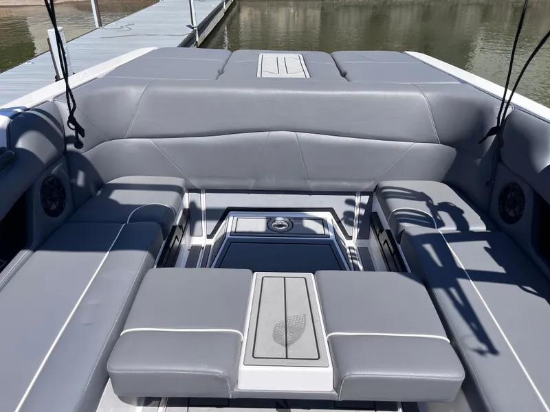 Slide: The Image of 2024 Moomba Max boat interior with gray seating and storage compartments. - 27