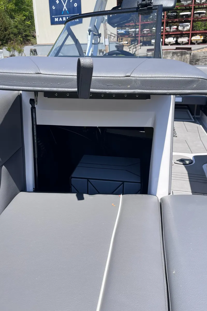 Slide: The Image of 2024 Moomba Max boat interior with gray seating and storage compartment. - 31