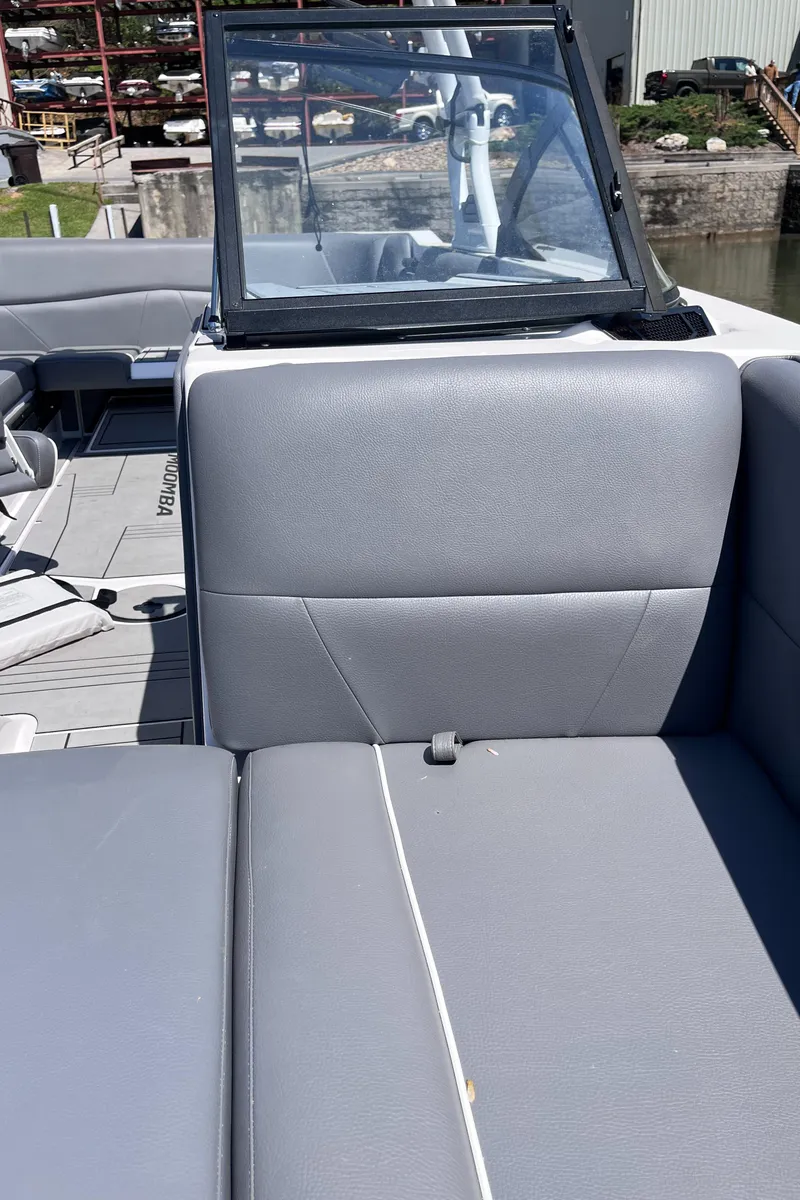 Slide: The Image of 2024 Moomba Max boat interior with gray seating and windshield. - 33