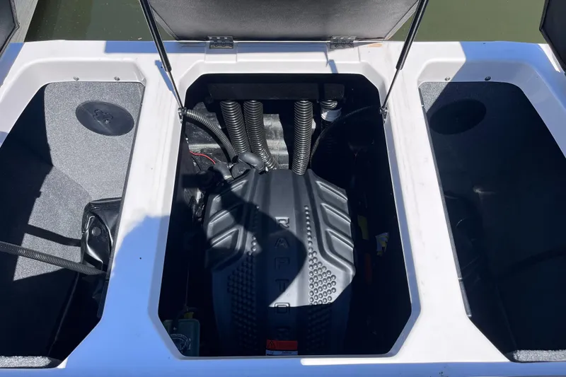 Slide: The Image of 2024 Moomba Max boat engine compartment with open hatches, showcasing engine details. - 37