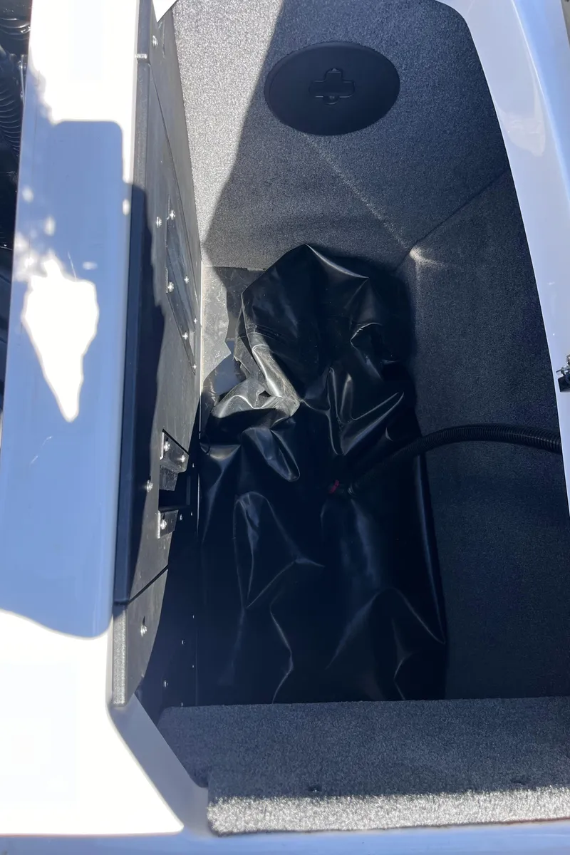 Slide: The Image of 2024 Moomba Max boat storage compartment with black interior lining. - 40