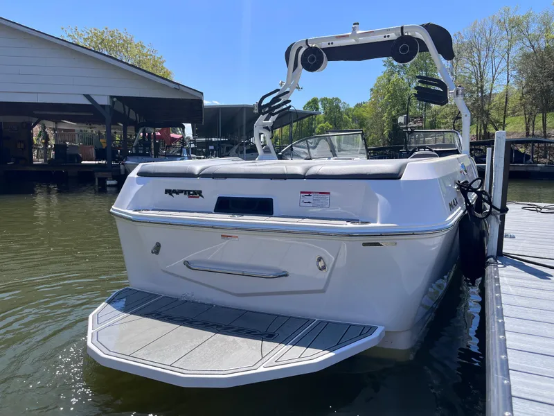 Slide: The Image of 2024 Moomba Max boat docked on a sunny day, showcasing sleek design and modern features. - 6