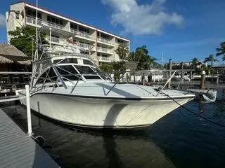 Slide: The Image of 2001 Carolina Classic 35 boat docked at marina under clear blue sky. - 1