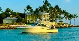 Slide: The Image of 2001 Carolina Classic 35 boat cruising near tropical shoreline with palm trees. - 10