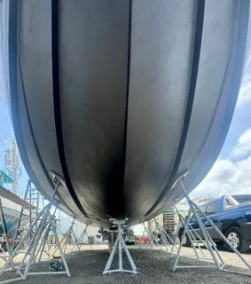 Slide: The Image of 2001 Carolina Classic 35 boat hull on stands, viewed from below. - 15