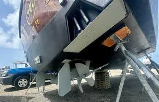 Slide: The Image of 2001 Carolina Classic 35 boat on stands, showing propellers and hull details. - 16