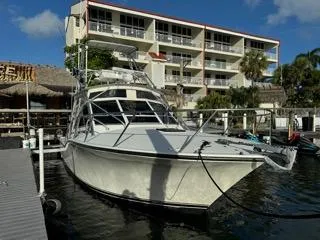 Slide: The Image of 2001 Carolina Classic 35 boat docked near waterfront building. - 2