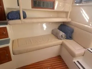 Slide: The Image of 2001 Carolina Classic 35 interior cabin with beige seating and wooden flooring. - 20