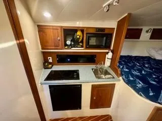 Slide: The Image of 2001 Carolina Classic 35 boat interior with kitchenette and bed. - 22