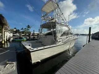 Slide: The Image of 2001 Carolina Classic 35 boat docked at marina under blue sky. - 3