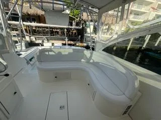 Slide: The Image of 2001 Carolina Classic 35 boat interior with white seating and marina view. - 8